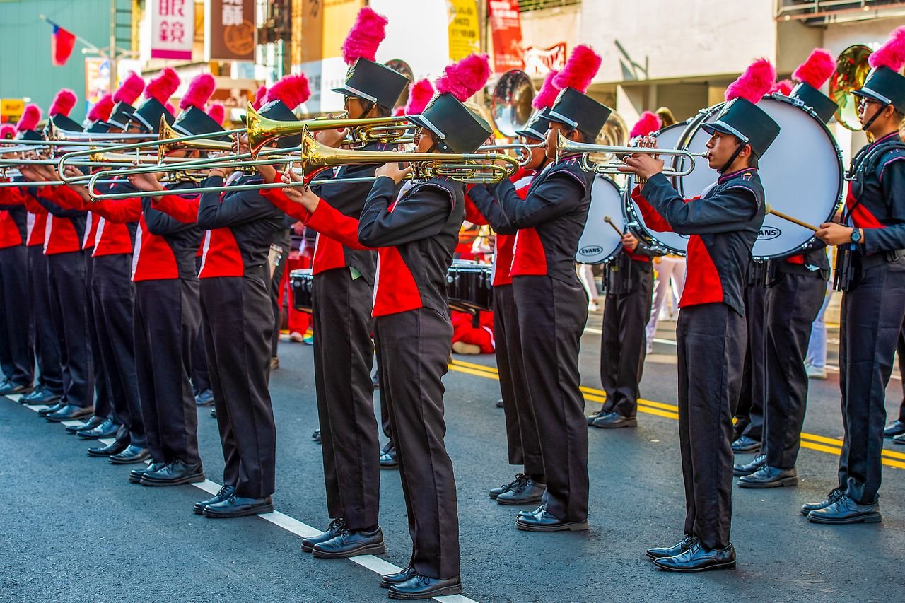 Crafting Captivating Headlines: Your awesome post title goes here Energetic marching band with vibrant attire performing outdoors in Taiwan.